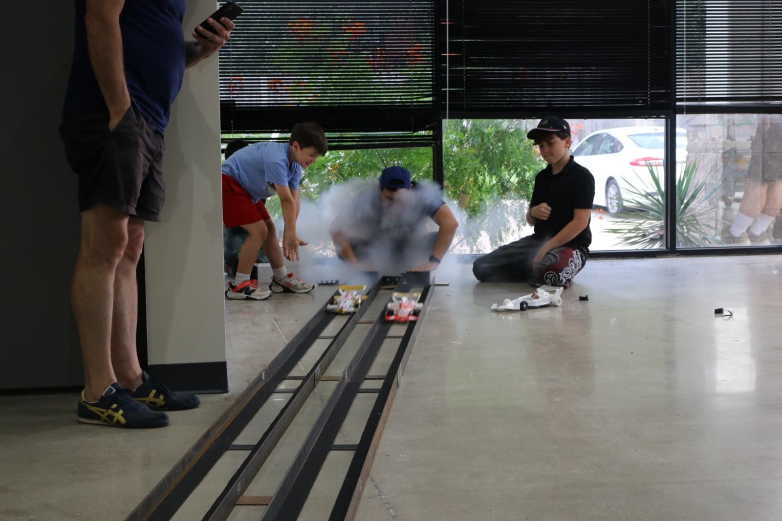 CO2 smoke flying as cars launch down the race track